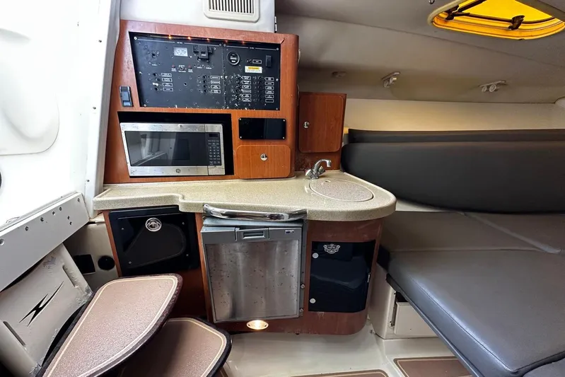  Yacht Photos Pics 2006 Hydra-Sports Vector 3300 VX cabin with kitchenette, microwave, and control panel.