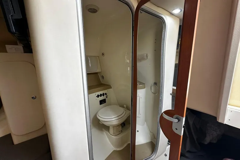  Yacht Photos Pics 2006 Hydra-Sports Vector 3300 VX boat bathroom interior with toilet and mirror.