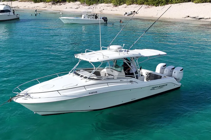  Yacht Photos Pics 2006 Hydra-Sports Vector 3300 VX boat anchored in clear turquoise water near a sandy beach.