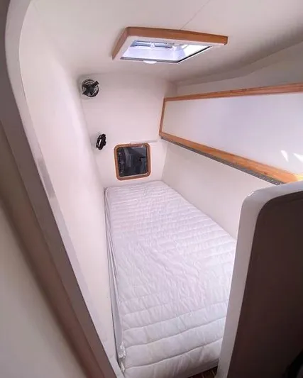 Saphira Yacht Photos Pics Compact cabin interior of 2018 Chris White Atlantic 70 "SAPHIRA" with single bed and porthole.