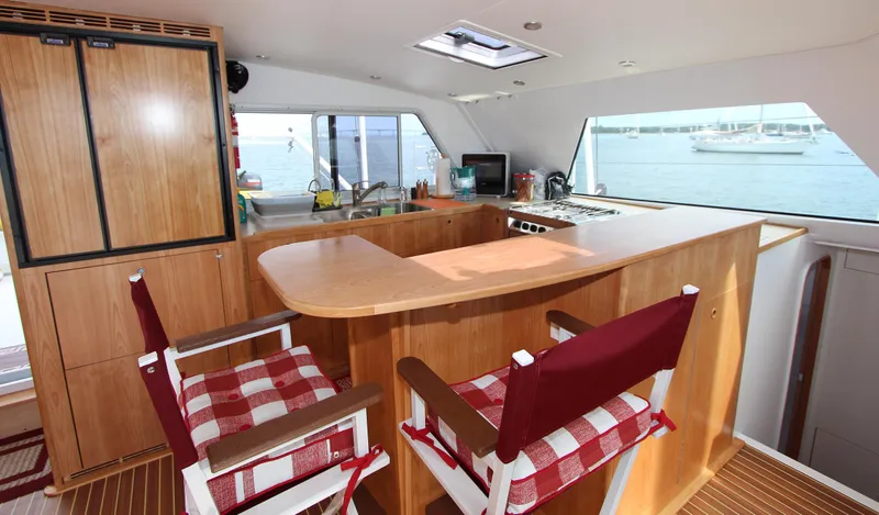 Saphira Yacht Photos Pics Luxurious interior of 2018 Chris White Atlantic 70 "SAPHIRA" yacht with wooden furnishings and ocean view.