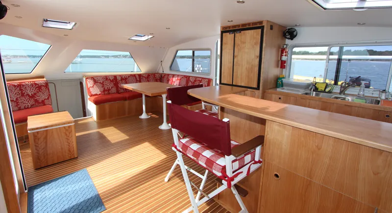 Saphira Yacht Photos Pics Luxurious interior of 2018 Chris White Atlantic 70 "SAPHIRA" yacht with wood finishes and seating.