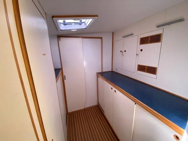 Saphira Yacht Photos Pics Interior of 2018 Chris White Atlantic 70 "SAPHIRA" yacht, featuring sleek cabinetry and skylight.