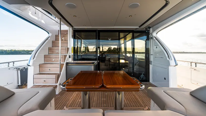 Stella Maris Yacht Photos Pics Luxurious 2022 Princess Y72 Motor Yacht with elegant outdoor seating and wooden table.