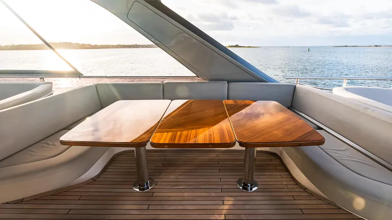 Stella Maris Yacht Photos Pics Luxurious 2022 Princess Y72 Motor Yacht interior with elegant wooden table and scenic ocean view.