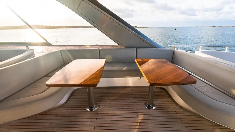 Stella Maris Yacht Photos Pics Luxurious 2022 Princess Y72 Motor Yacht interior with elegant wooden tables and ocean view.