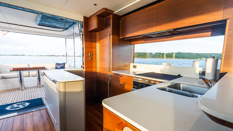 Stella Maris Yacht Photos Pics Luxurious interior of 2022 Princess Y72 Motor Yacht with modern kitchen and scenic view.