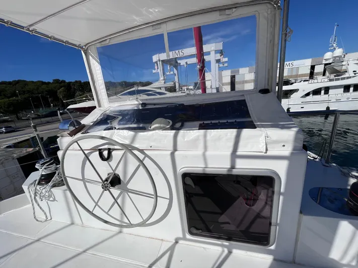  Yacht Photos Pics 2025 Catana Taino 21 Day Charter yacht helm with steering wheel and marina view.