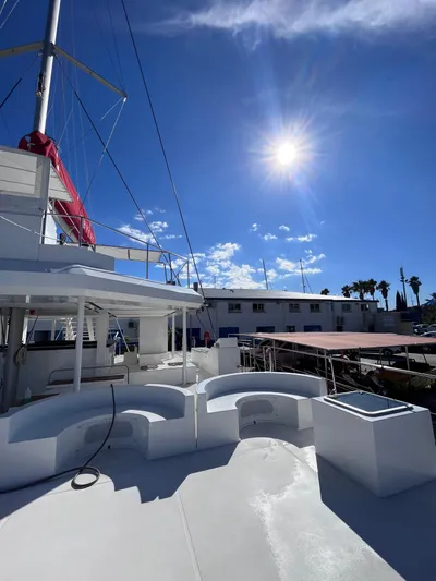  Yacht Photos Pics Catana Taino 21 Day Charter 2025 yacht under bright sun, docked with clear blue sky.