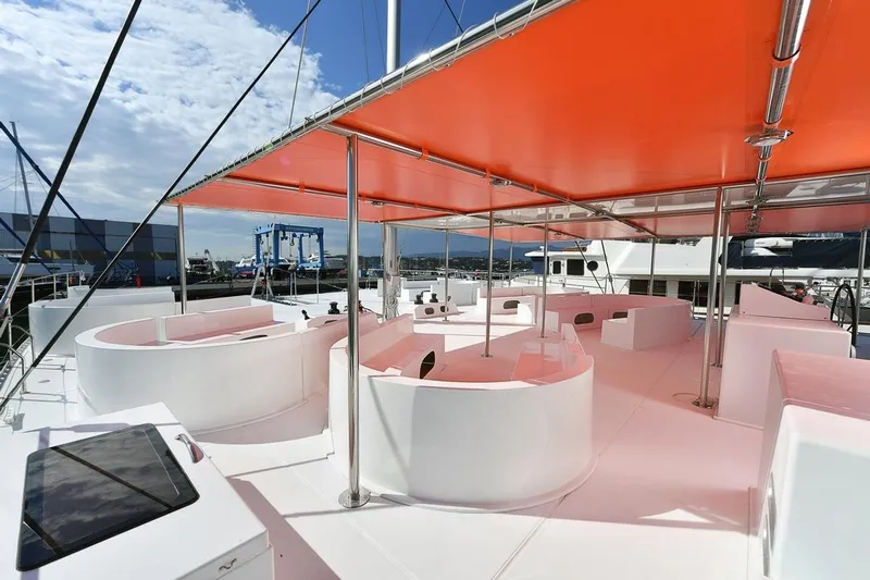  Yacht Photos Pics Modern Catana Taino 21 Day Charter yacht with orange canopy, 2025 model, docked at marina.