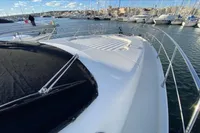 2007 Azimut 68E yacht docked in a marina, surrounded by sailboats.