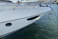 2007 Azimut 68E yacht docked in marina, sleek white hull design.