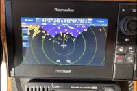 Raymarine navigation system on 2007 Azimut 68E yacht displaying radar and GPS coordinates.