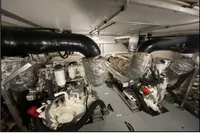 Engine room of a 2007 Azimut 68E yacht, showcasing dual engines and exhaust systems.