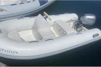 Small inflatable boat with Honda motor, docked beside Azimut 68E yacht, 2007 model.