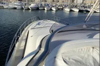 2007 Azimut 68E yacht docked in a marina, surrounded by other boats.
