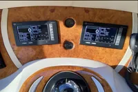 Dashboard of a 2007 Azimut 68E yacht with dual digital displays and compass.