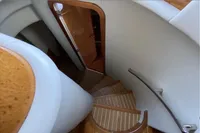Staircase inside 2007 Azimut 68E yacht, featuring elegant wood and modern design.