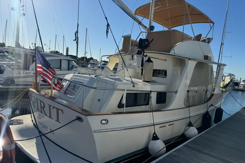  Yacht Photos Pics Pacific Seacraft 38T Fast Trawler, 2000 model, docked with American flag, sunny marina.