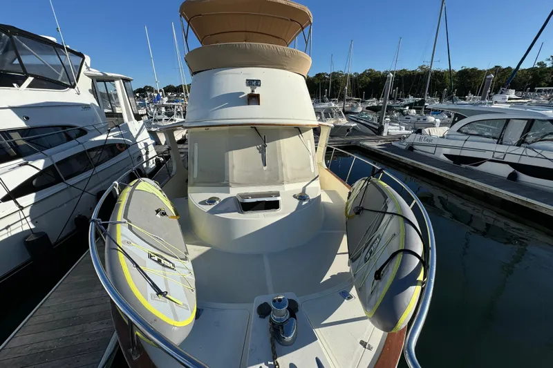  Yacht Photos Pics 2000 Pacific Seacraft 38T Fast Trawler docked with paddleboards, surrounded by other boats.