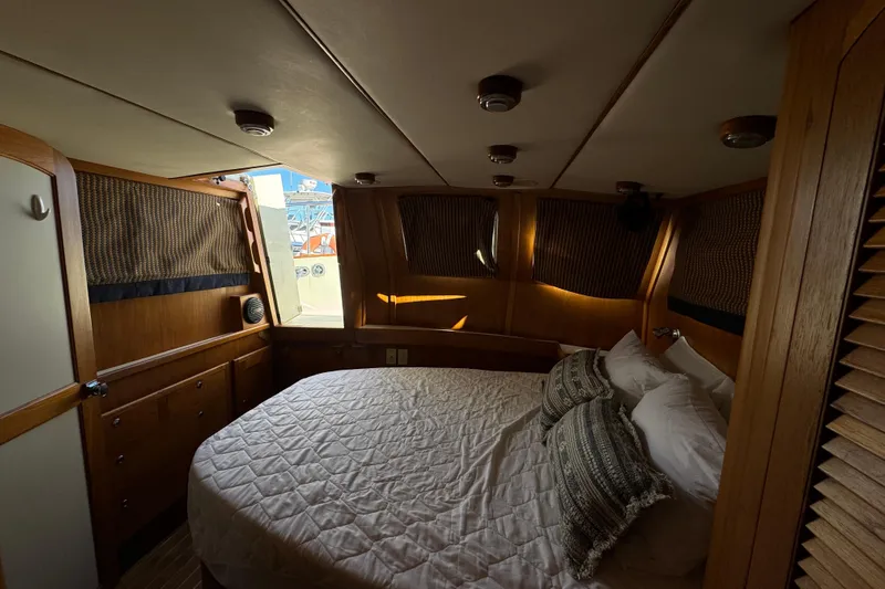  Yacht Photos Pics Cozy cabin interior of 2000 Pacific Seacraft 38T Fast Trawler with bed and wooden furnishings.