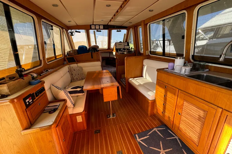  Yacht Photos Pics Interior of 2000 Pacific Seacraft 38T Fast Trawler with wood finish and seating area.