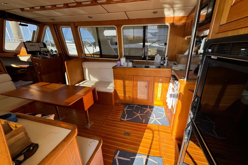  Yacht Photos Pics Interior of 2000 Pacific Seacraft 38T Fast Trawler with wooden furnishings and kitchenette.