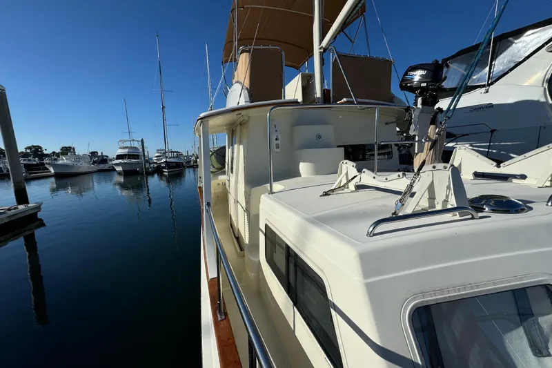  Yacht Photos Pics Pacific Seacraft 38T Fast Trawler, 2000 model, docked in a marina under clear blue sky.