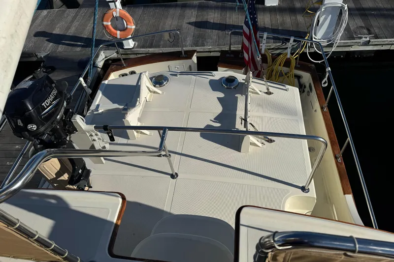  Yacht Photos Pics Pacific Seacraft 38T Fast Trawler 2000, deck view with Tohatsu motor and American flag.