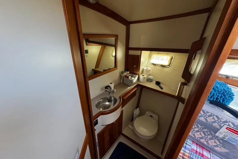  Yacht Photos Pics Bathroom interior of 2000 Pacific Seacraft 38T Fast Trawler with sink, toilet, and storage.