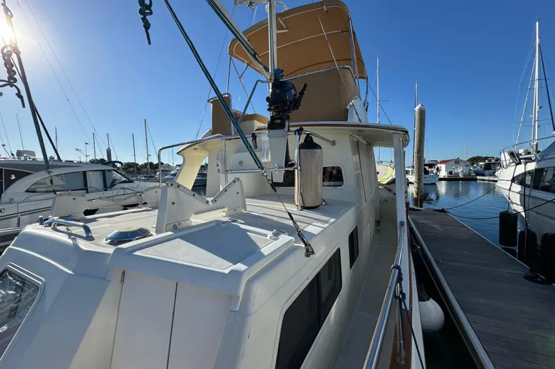  Yacht Photos Pics 2000 Pacific Seacraft 38T Fast Trawler docked at marina under clear blue sky.