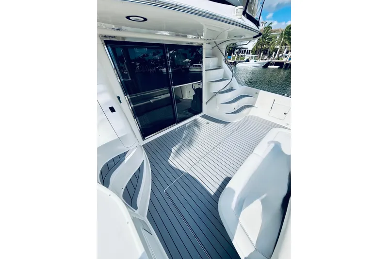 Rogue One Yacht Photos Pics 2003 Sea Ray 560 Sedan Bridge yacht deck with sleek seating and waterfront view.