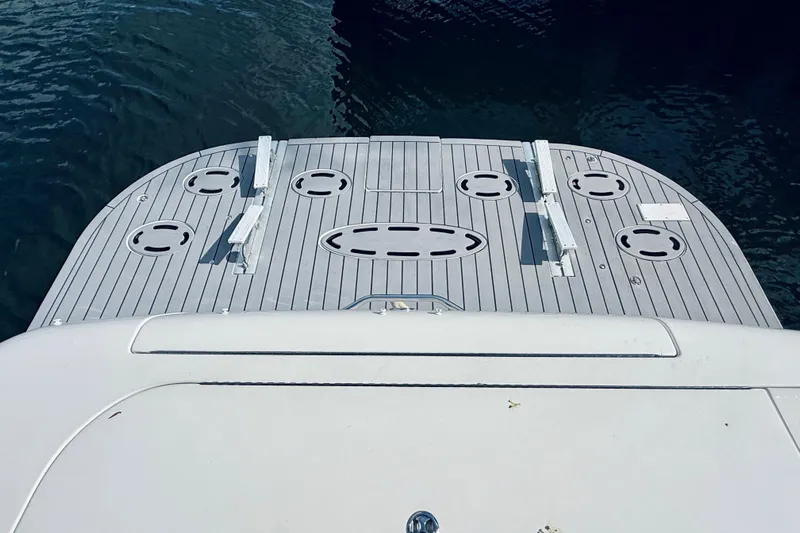 Rogue One Yacht Photos Pics Rear deck of 2003 Sea Ray 560 Sedan Bridge yacht, featuring sleek design and water backdrop.