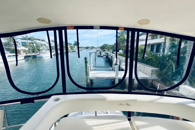 Rogue One Yacht Photos Pics View from 2003 Sea Ray 560 Sedan Bridge yacht, overlooking a serene waterfront dock.