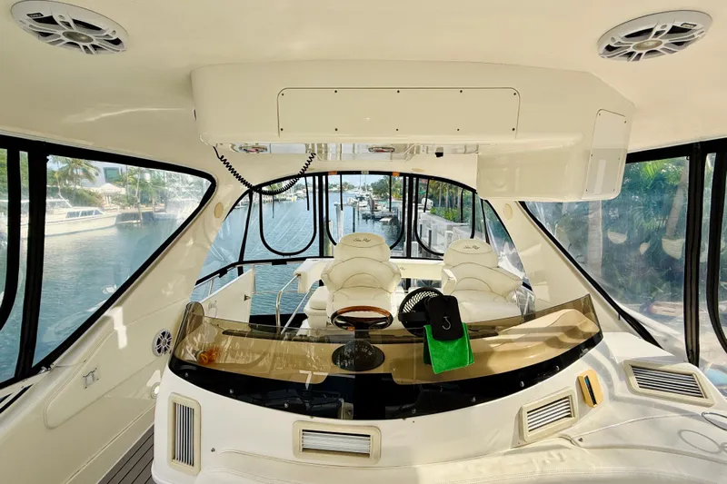 Rogue One Yacht Photos Pics Interior view of 2003 Sea Ray 560 Sedan Bridge yacht, featuring luxurious seating and helm.