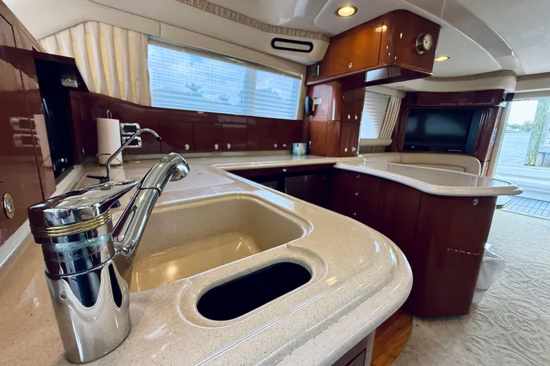 Rogue One Yacht Photos Pics Luxurious 2003 Sea Ray 560 Sedan Bridge yacht interior with modern kitchen and elegant design.