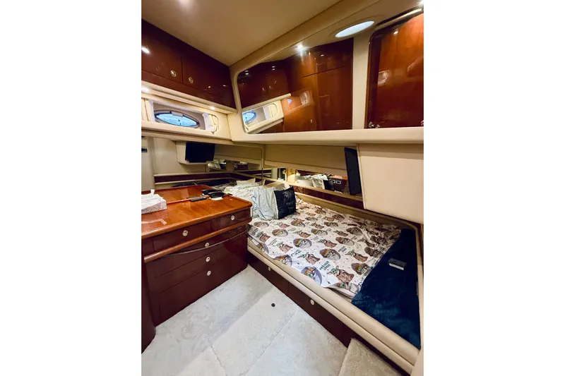 Rogue One Yacht Photos Pics Luxurious cabin interior of 2003 Sea Ray 560 Sedan Bridge yacht with wood cabinetry.
