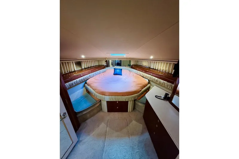 Rogue One Yacht Photos Pics Luxurious 2003 Sea Ray 560 Sedan Bridge yacht bedroom interior with elegant bedding.