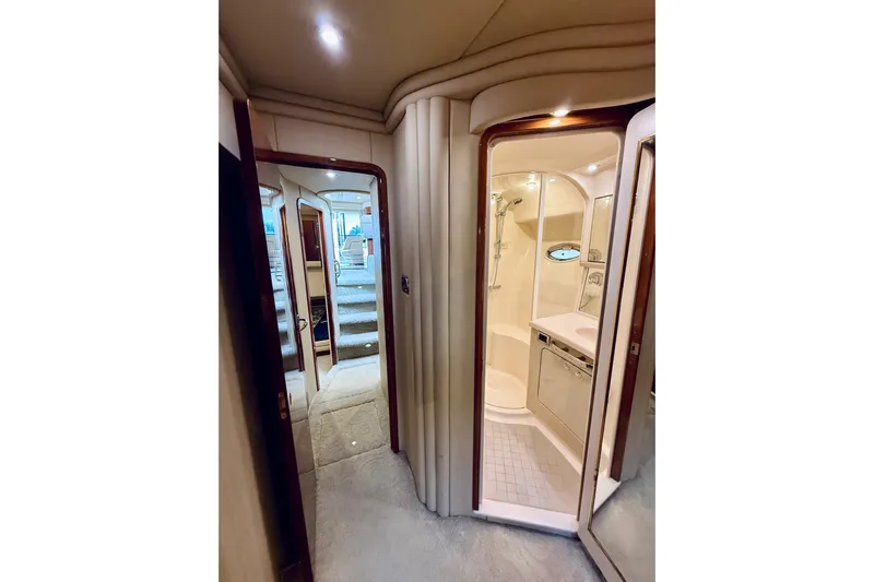 Rogue One Yacht Photos Pics Interior of 2003 Sea Ray 560 Sedan Bridge yacht, featuring a bathroom and hallway.