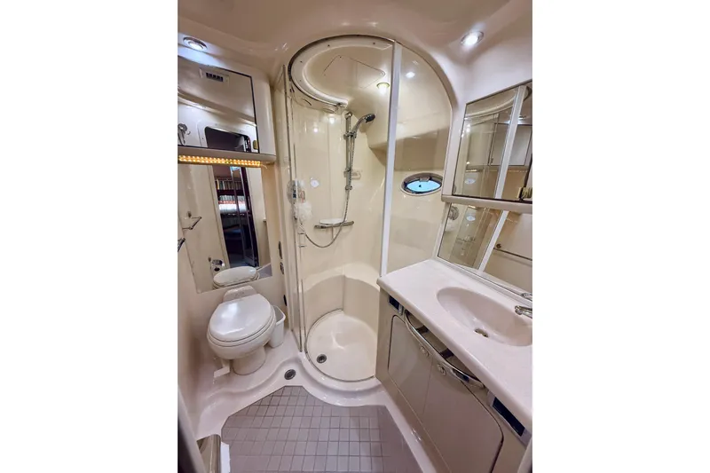 Rogue One Yacht Photos Pics Luxurious bathroom in 2003 Sea Ray 560 Sedan Bridge yacht with shower and vanity.