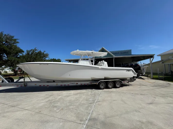  Yacht Photos Pics 2020 Invincible 39 Open Fisherman boat on trailer, parked outdoors under clear blue sky.