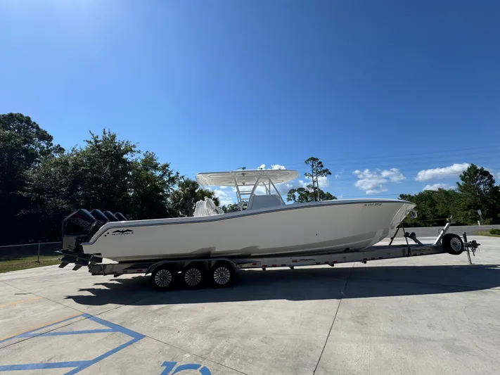  Yacht Photos Pics 2020 Invincible 39 Open Fisherman boat on trailer under clear blue sky.
