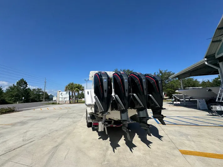  Yacht Photos Pics 2020 Invincible 39 Open Fisherman with four powerful outboard engines, parked outdoors.