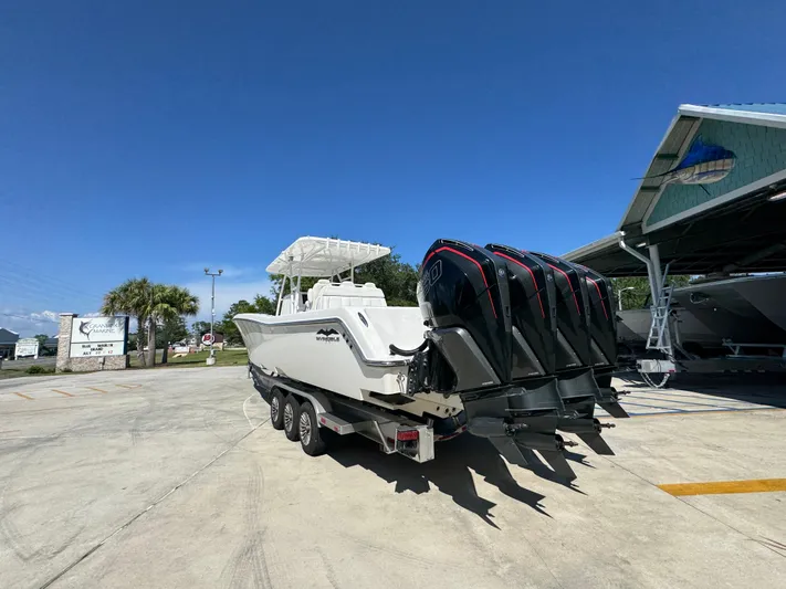  Yacht Photos Pics 2020 Invincible 39 Open Fisherman boat with four powerful outboard engines in a marina.