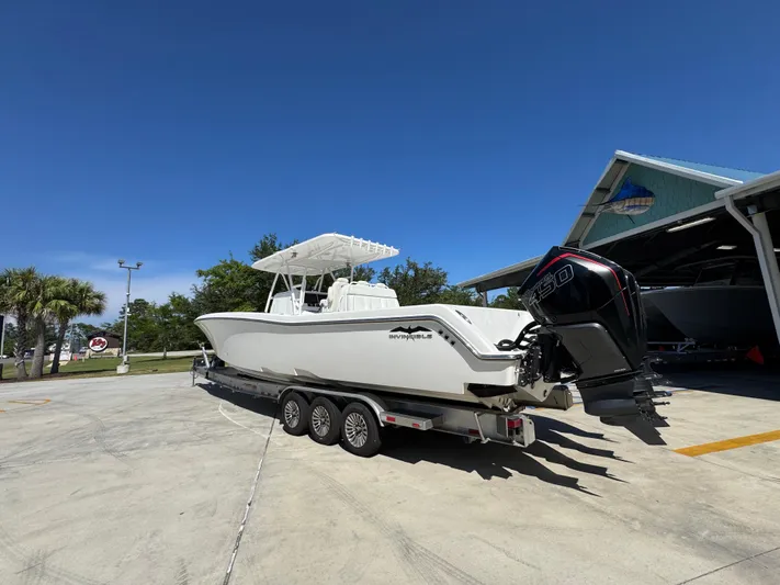  Yacht Photos Pics 2020 Invincible 39 Open Fisherman boat on trailer, parked outdoors under clear blue sky.
