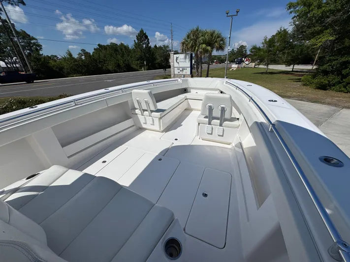  Yacht Photos Pics 2020 Invincible 39 Open Fisherman boat interior with seating, docked outdoors.
