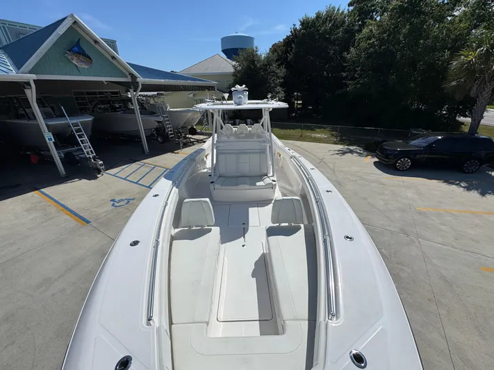  Yacht Photos Pics 2020 Invincible 39 Open Fisherman boat docked at a marina under clear skies.