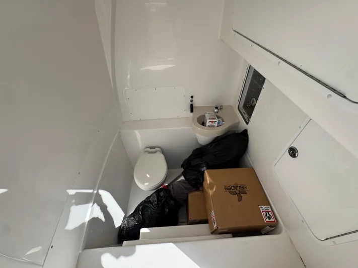  Yacht Photos Pics Interior of 2020 Invincible 39 Open Fisherman boat with toilet and storage items.