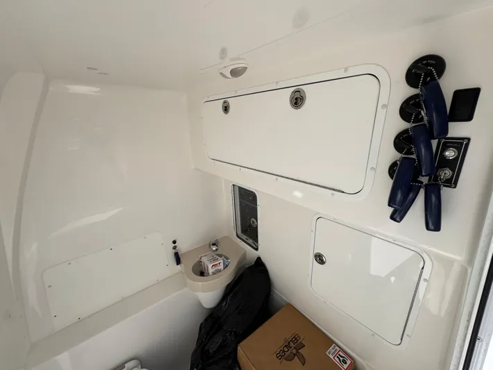  Yacht Photos Pics Interior of 2020 Invincible 39 Open Fisherman boat with storage compartments and controls.