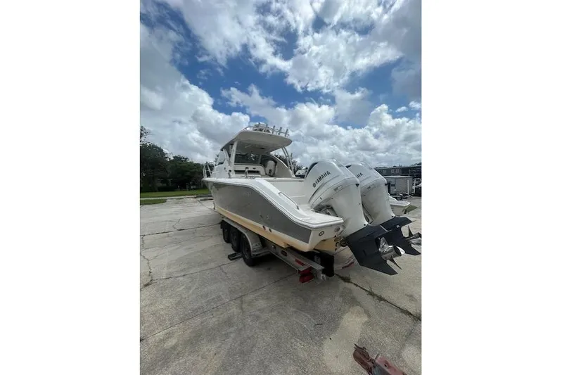  Yacht Photos Pics 2020 Pursuit OS 325 Offshore boat with dual Yamaha engines on a trailer.